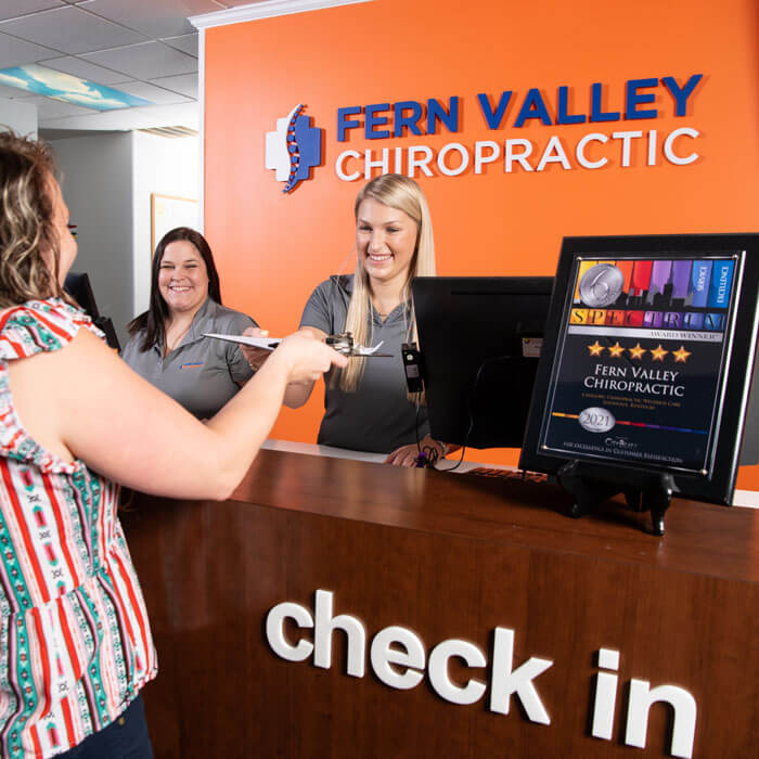 patient checking in at front desk inside Fern Valley Chiropractic